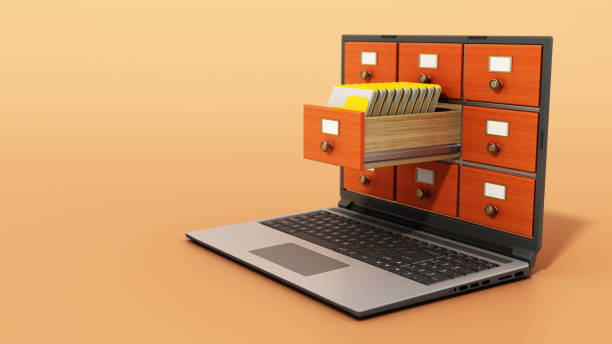 File cabinets or catalogue drawers inside the laptop screen. Folders standing inside the drawer stock photo
