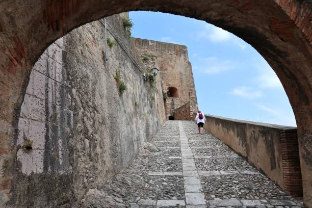 Scilla - Tourist on the access ramp to the Ruffo Castle Scilla, Calabria, Italy – June 13, 2021: Tourist on the access ramp of Castello Ruffo castle scilla stock pictures, royalty-free photos & images