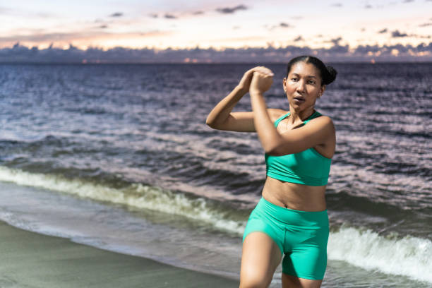 istock Afro woman doing some warm-up exercises before running. 1444128972