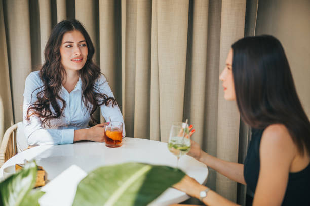 istock Two young women having drinks at the restaurant table, spending time together 1444130249