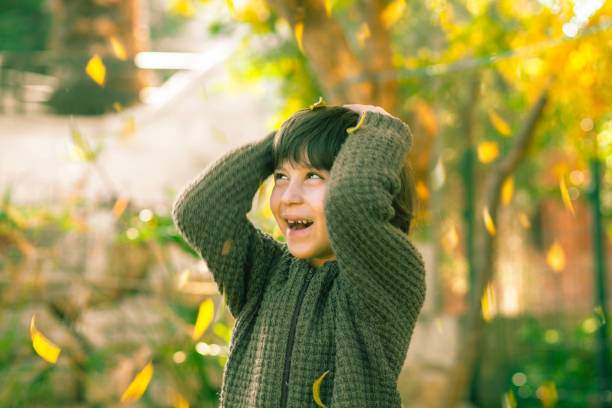 Portrait of a happy and cute child playing in the garden.