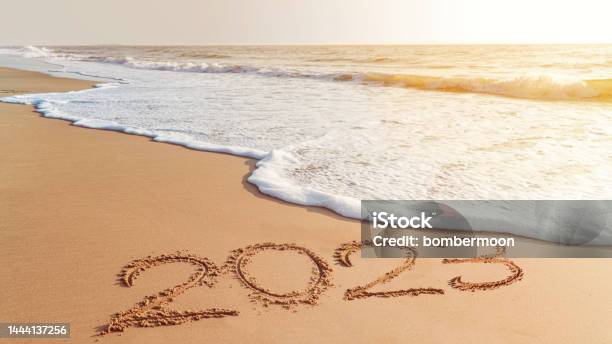 The Year 2023 Handwriting On Sand Beach Happy New Year Coming Concept White Waves Are Lapping Toward The Shore Stock Photo - Download Image Now