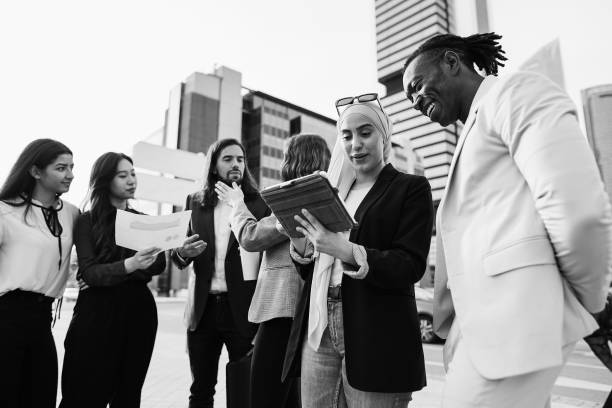 Multiracial business people working outdoor from office building
