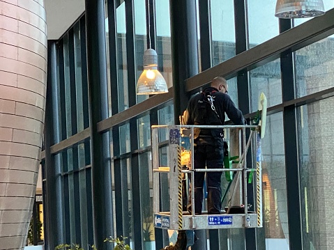 Brunssum,  Netherlands- November 21,  2022. Professional window cleaning  on top af a cherry picker.