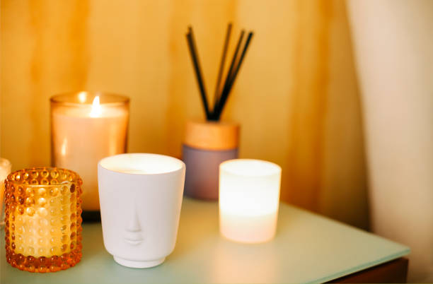 istock Many burning lighting scented candles and aromatic incense sticks on table, meditation place at home 1444142989