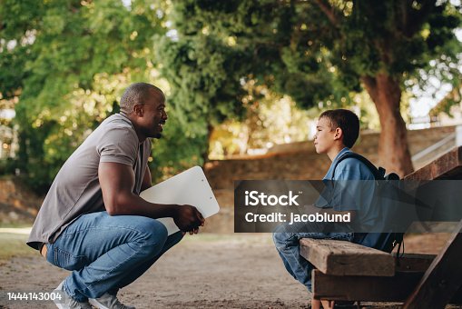 istock Mentor talking to a young school kid outside class 1444143004