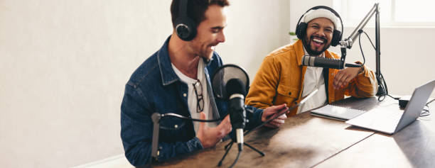 istock Podcasters laughing and having a good time in a studio 1444143315