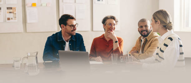 Happy business colleagues having a meeting in a creative office