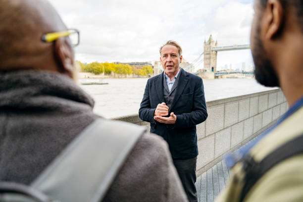 istock British guide talking with father and son vacationers 1444144353