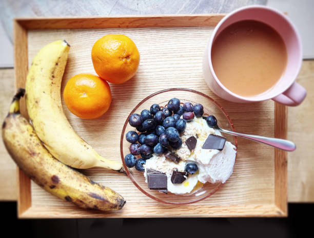 Breakfast tray with fruits and tea stock photo