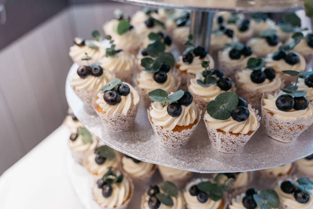 istock Small cupcakes with frosting and blueberries on a cake stand 1444144807