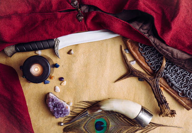 istock Fantasy live action role play game concept. Background decorated with various character objects tools: Dagger, chain mail, cape, clothing, drinking horn. Vintage style, copy space in center. 1444145050