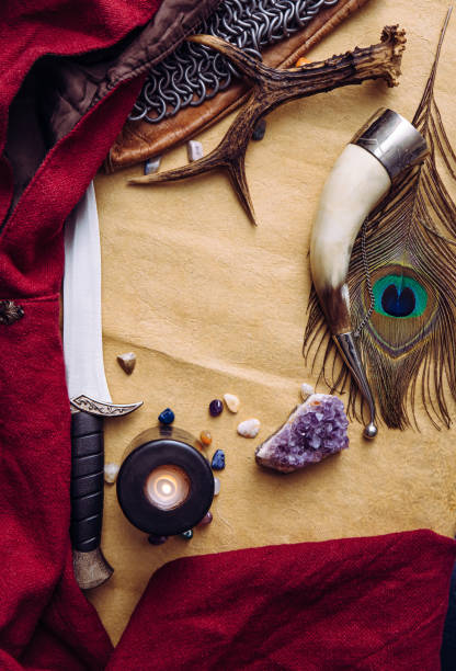 istock Fantasy live action role play game concept. Background decorated with various character objects tools: Dagger, chain mail, cape, clothing, drinking horn. Vintage style, copy space in center. 1444145110
