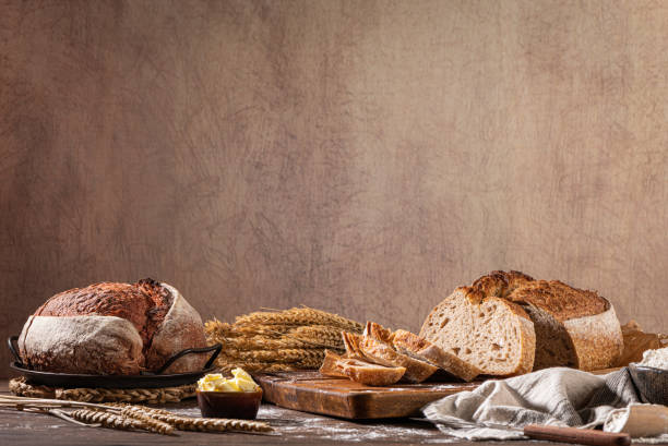 freshly artisan baked wheat and rye bread, country bread. simple bread  with butter for breackfast - country bread imagens e fotografias de stock