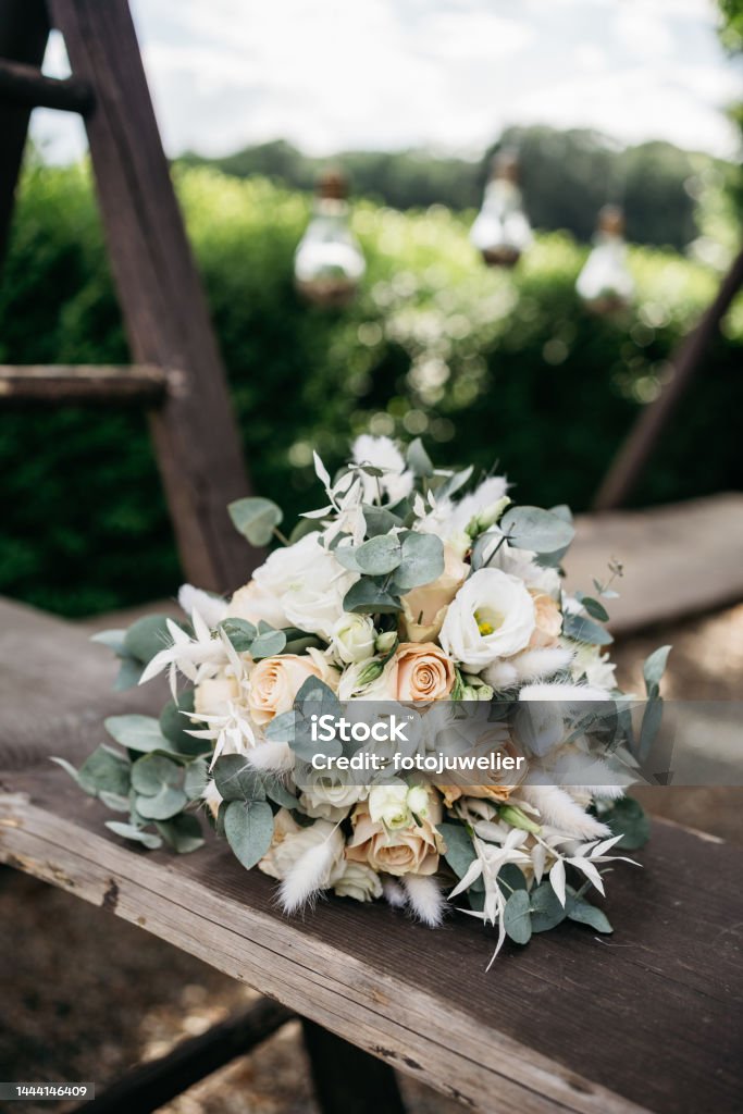 Light coloured wedding bouquet Light coloured wedding bouquet lying on a wooden board Beauty Stock Photo
