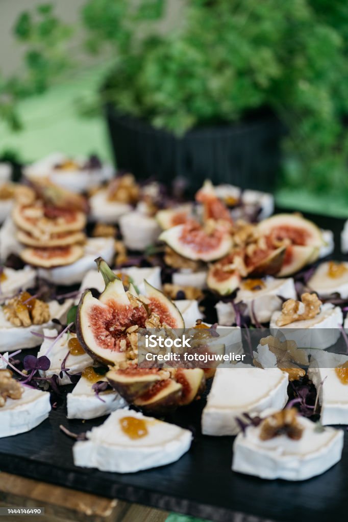 Soft cheese and figs served on a slate plate Buffet Stock Photo