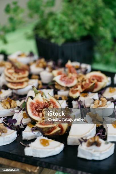 Soft Cheese And Figs Served On A Slate Plate Stock Photo - Download Image Now - Buffet, Celebration, Cheese