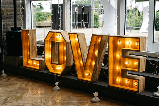 Big wooden letter of the word LOVE with light bulbs