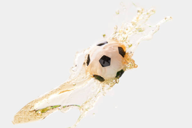 istock Soccer ball in beer splash on white background. 1444148972