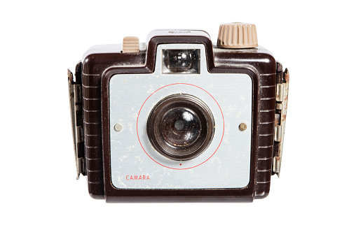 Film camera and some dia slides with blank instant photographs on white background