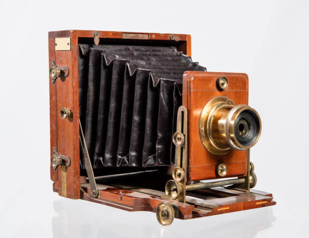 istock Retro film photo camera isolated on white background. 1444154573