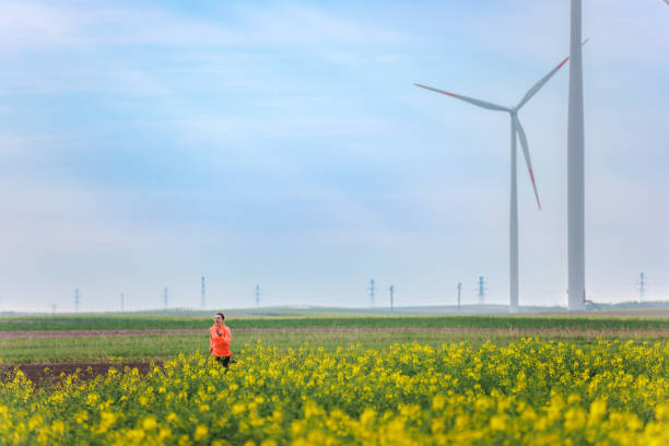 istock Running in the rural fields with wind farm 1444157885