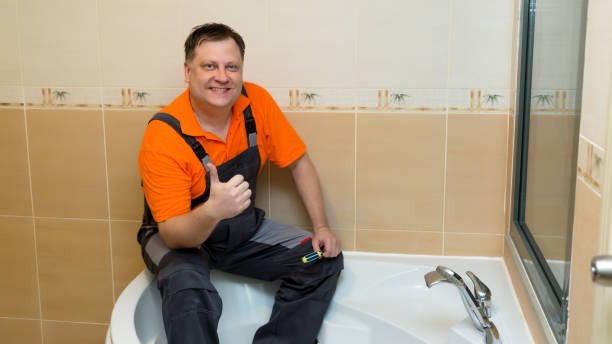 istock A man with a screwdriver sits on a large bathtub after renovation 1444161486