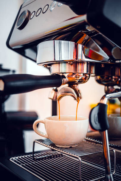 istock Coffee extraction from the coffee machine with a portafilter pouring coffee into a cup,Espresso poruing from coffee machine at coffee shop 1444162075