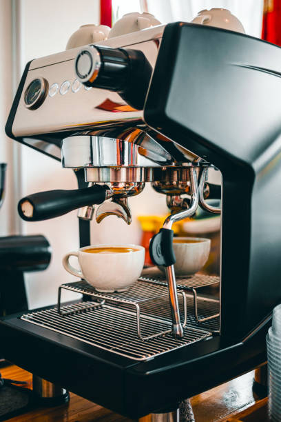 istock Coffee extraction from the coffee machine with a portafilter pouring coffee into a cup,Espresso poruing from coffee machine at coffee shop 1444162196