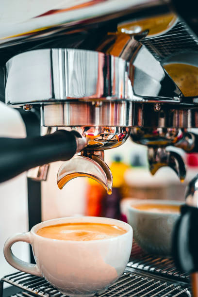 istock Coffee extraction from the coffee machine with a portafilter pouring coffee into a cup,Espresso poruing from coffee machine at coffee shop 1444162246