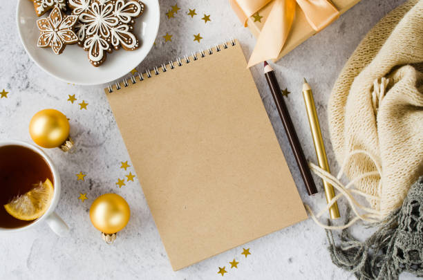istock Flat lay of blank brown notebook with gift box, tea, cookies and plaid. 1444162721