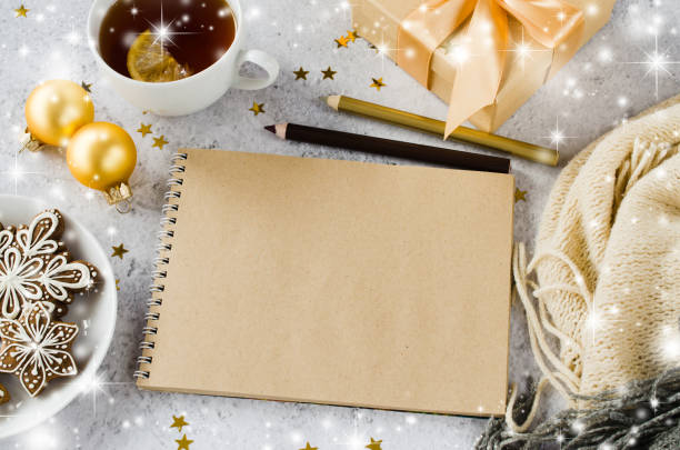istock Flat lay of blank brown notebook with gift box, tea, cookies and plaid. 1444162763