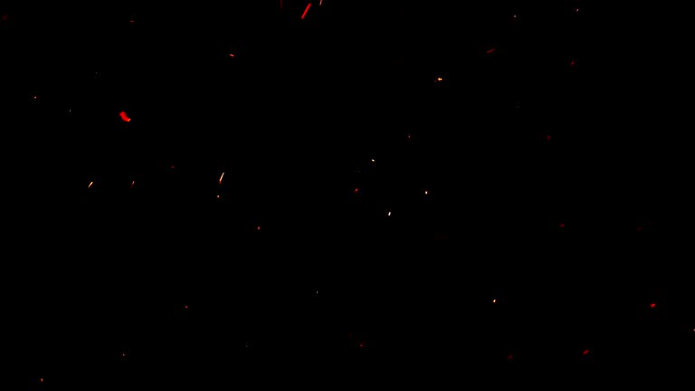 Soft hot ember particles on black ideal for overlays. The glowing embers float gently in the night air