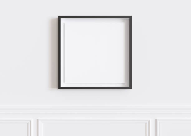 istock Blank square picture frame hanging on white wall. Template, mock up for your artwork, picture or poster. Empty, copy space. Close up view. Simple, minimalist mockup. 3D rendering. 1444170509