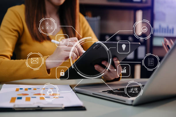 istock businessman working with mobile phone and tablet and laptop computer Internet with Augmented Reality on VR dashboard on desk in office 1444171773