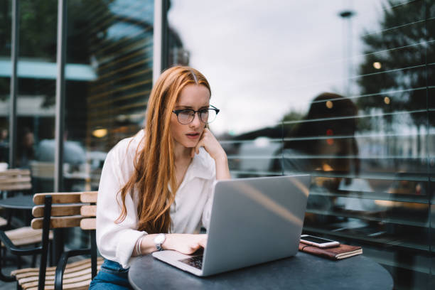istock Serious woman with laptop working on project 1444172959