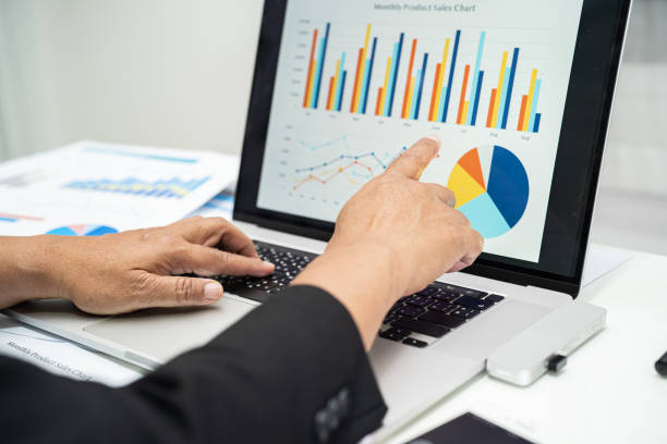 istock Asian accountant working and analyzing financial reports project accounting with chart graph and calculator in modern office, finance and business concept. 1444175501