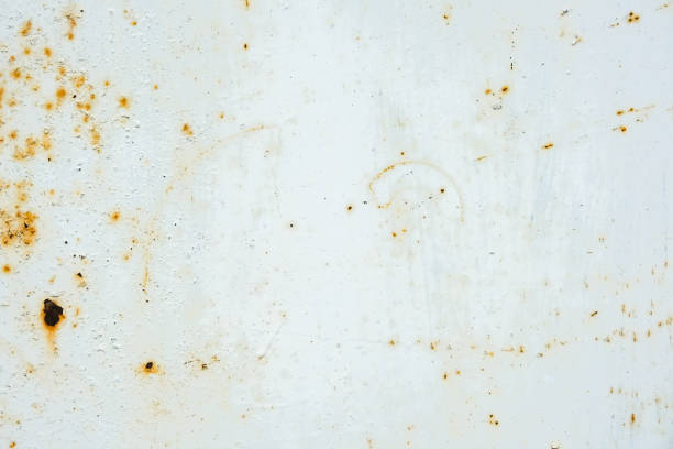 istock Corrosion metal. Rust shows through the white paint. Rusty texture. 1444176084