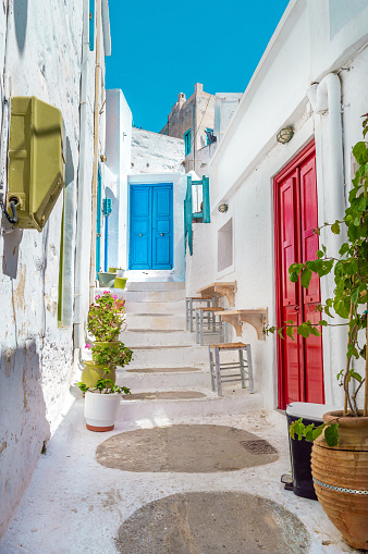 Traditional cycladitic alley with a narrow street and whitewashed houses in Amorgos Greece  22 July 2022