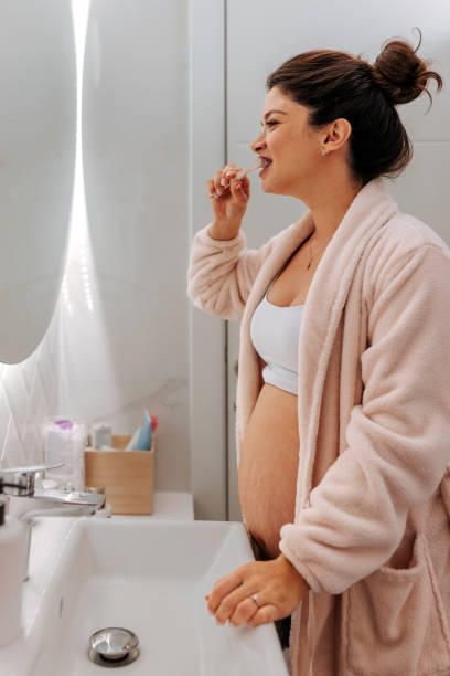 istock Pregnant woman brushing teeth in bathroom. 1444178046