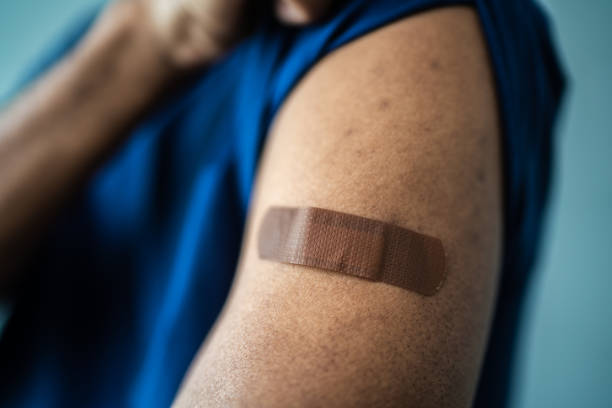 istock Man's arm with a bandage on a studio shot 1444178505