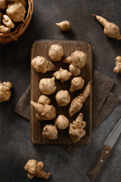 istock Cooking Jerusalem artichoke root, sunchoke on cutting board. 1444178925