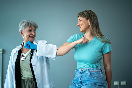 Doctor and patient doing an elbow bump
