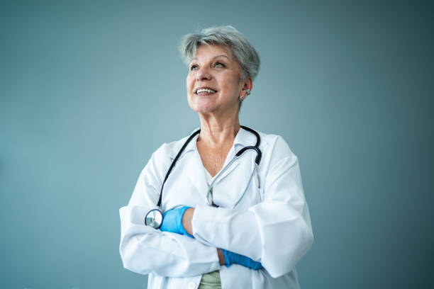 Doctor looking away on a gray background on a studio shot