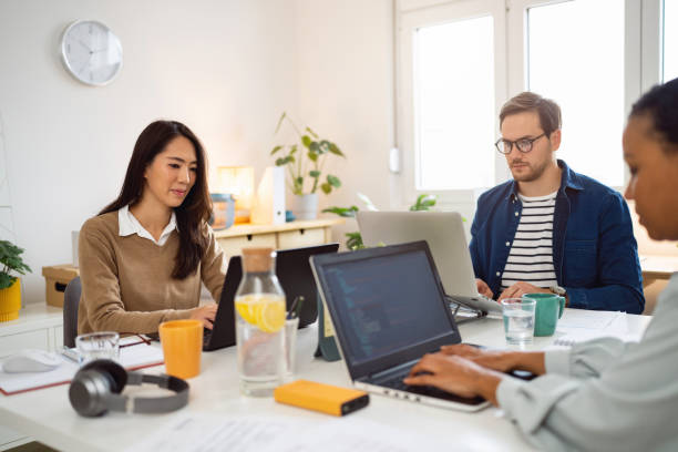 istock Small group of business people working together at the office 1444184521