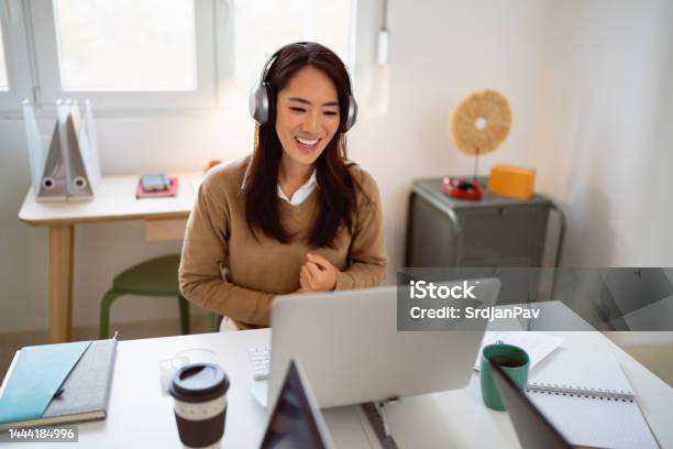 Young Asian Ethnicity Businesswoman Having A Video Conference At Her Office Stock Photo - Download Image Now