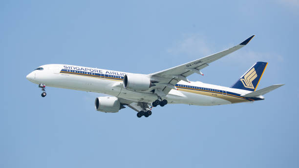 The aircraft airbus A350 of Singapore Airlines with registration 9V-SHE The aircraft of Singapore Airlines on the way to landing at Tan Son Nhat international Airport, Ho Chi Minh city, Viet Nam. landing craft stock pictures, royalty-free photos & images