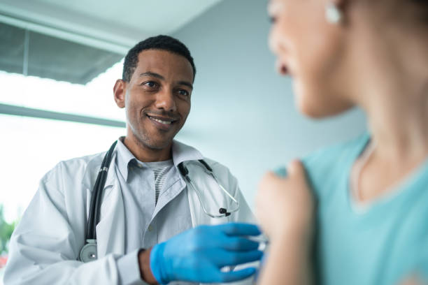 istock Doctor vaccinating a woman 1444188751