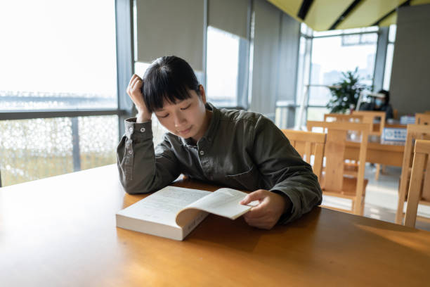 istock A woman was reading in the library 1444188995