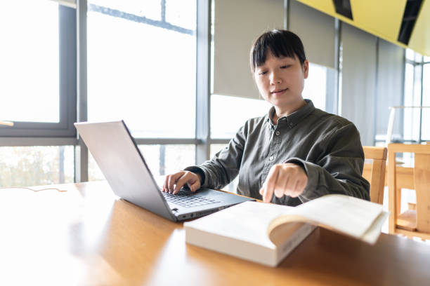 istock A woman was studying on a laptop in the library 1444189077